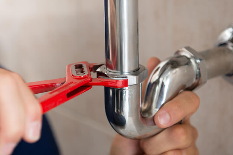 Plumber Fixing a Pipe