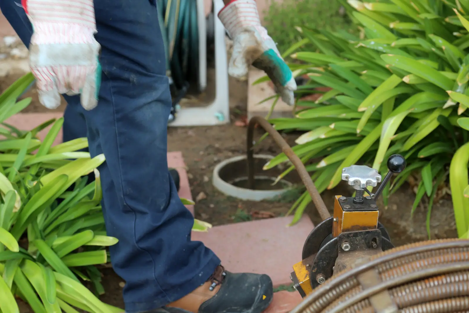 How to clear a main sewer line clog starting at the outdoor cleanout with a drain cable