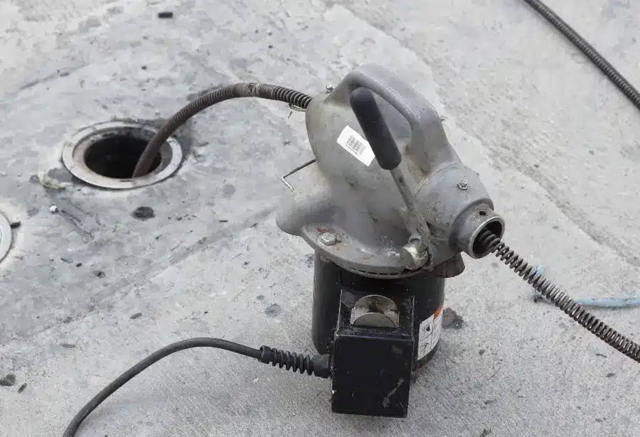 Compact rooter service drain machine with cable sized for a small floor drain line